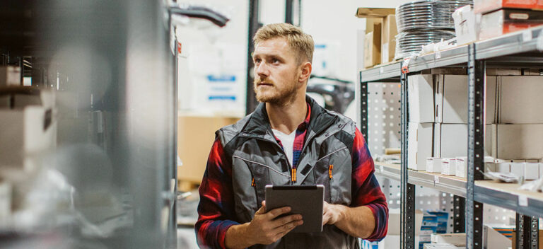 A business owner checking stock and considering his small business growth