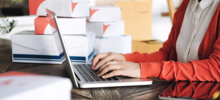Picture of woman at computer looking at cash flow finance