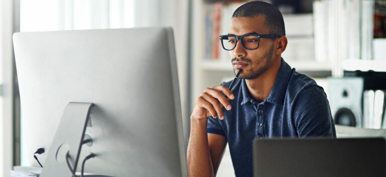 Man at computer comparing business credit card options