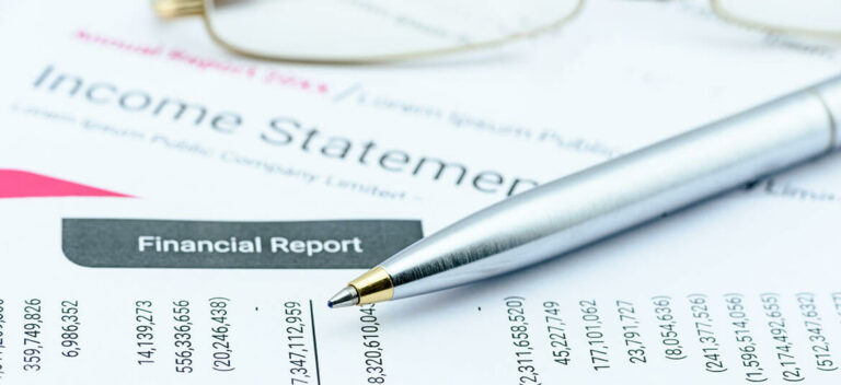 showing income statement with pen, also called a profit and loss statement