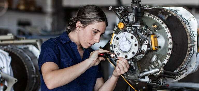 A young apprentice working on a machine