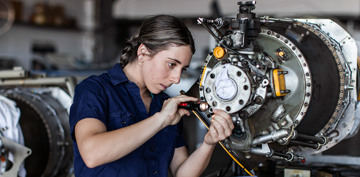 A young apprentice working on a machine