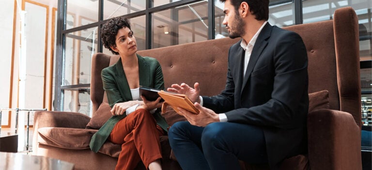 Accountand and his client sitting on a couch discussing taxation issues